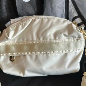 Cream Nike Crossbody bag with gold hardware
